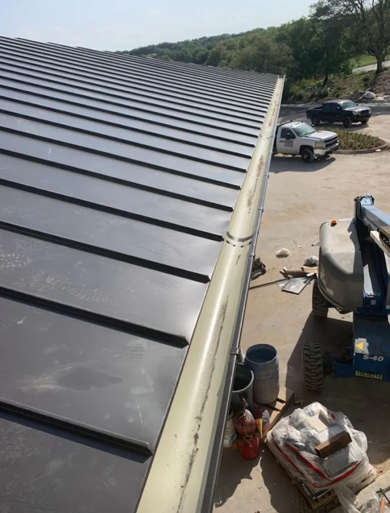 Standing seam panel and gutter detail on a metal roofing jobsite in Middleburg Heights